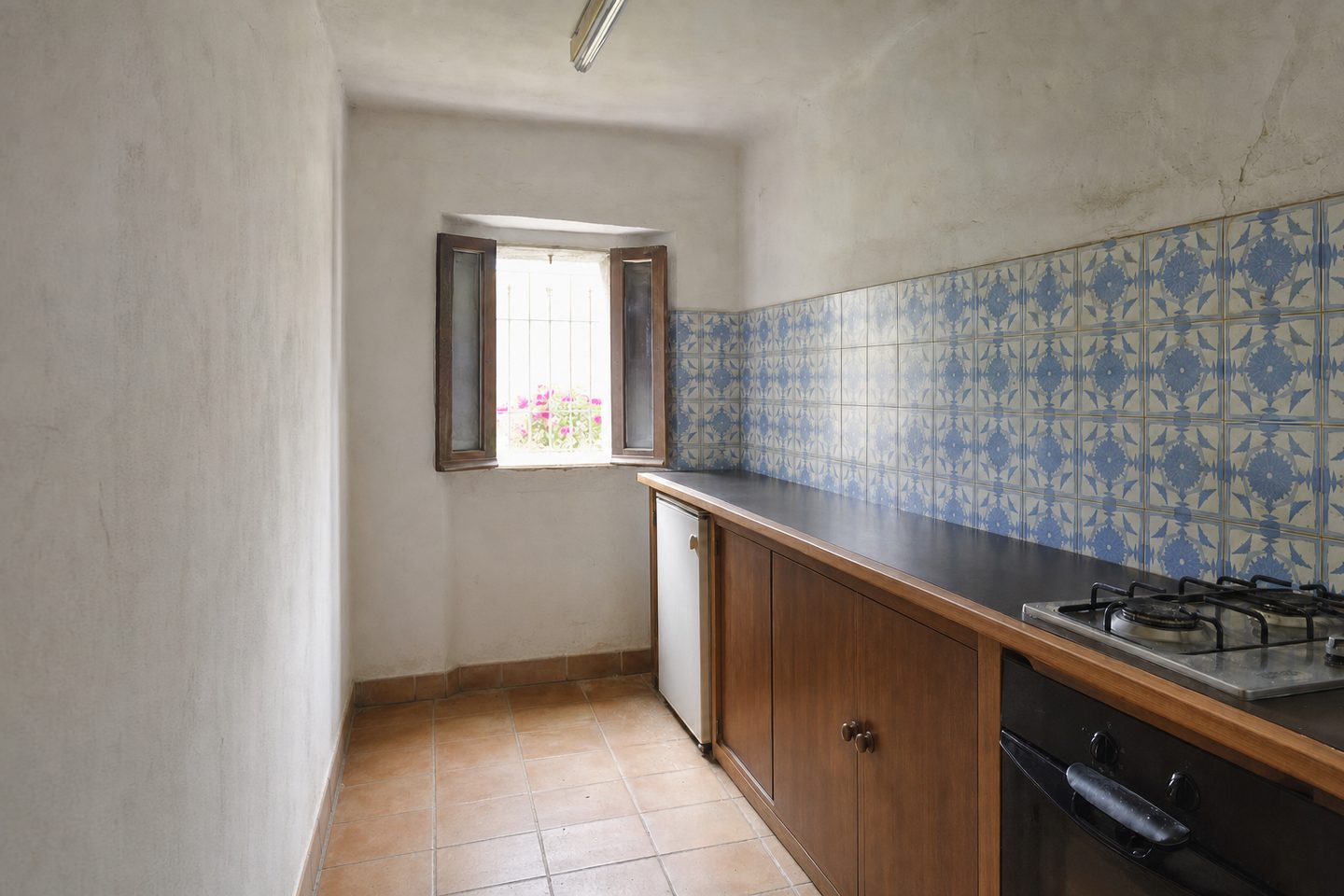 A compact village kitchen with blue tiles — Decluttered